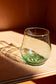 aqua short glass with red background
