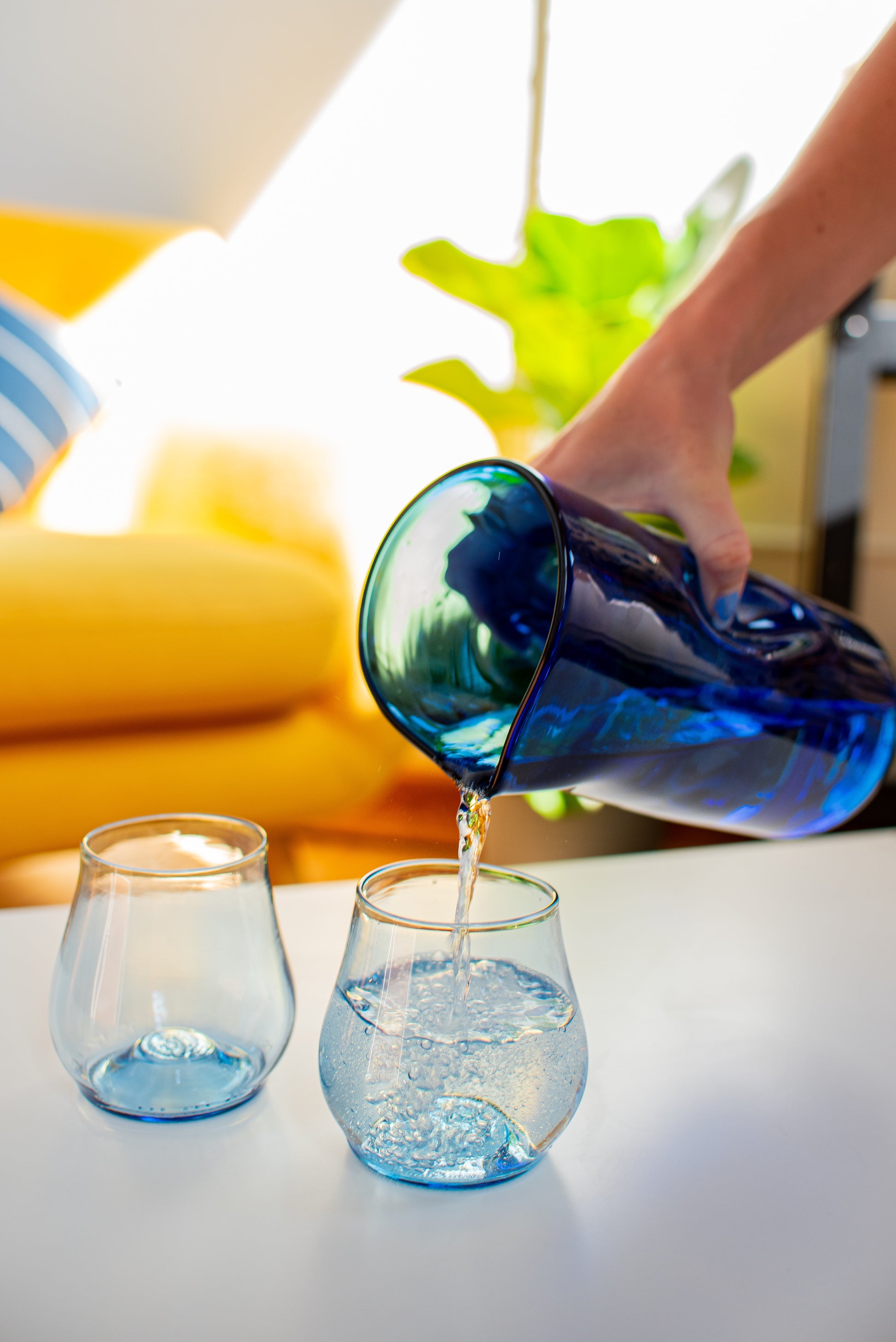 two cups being poured into with pitcher