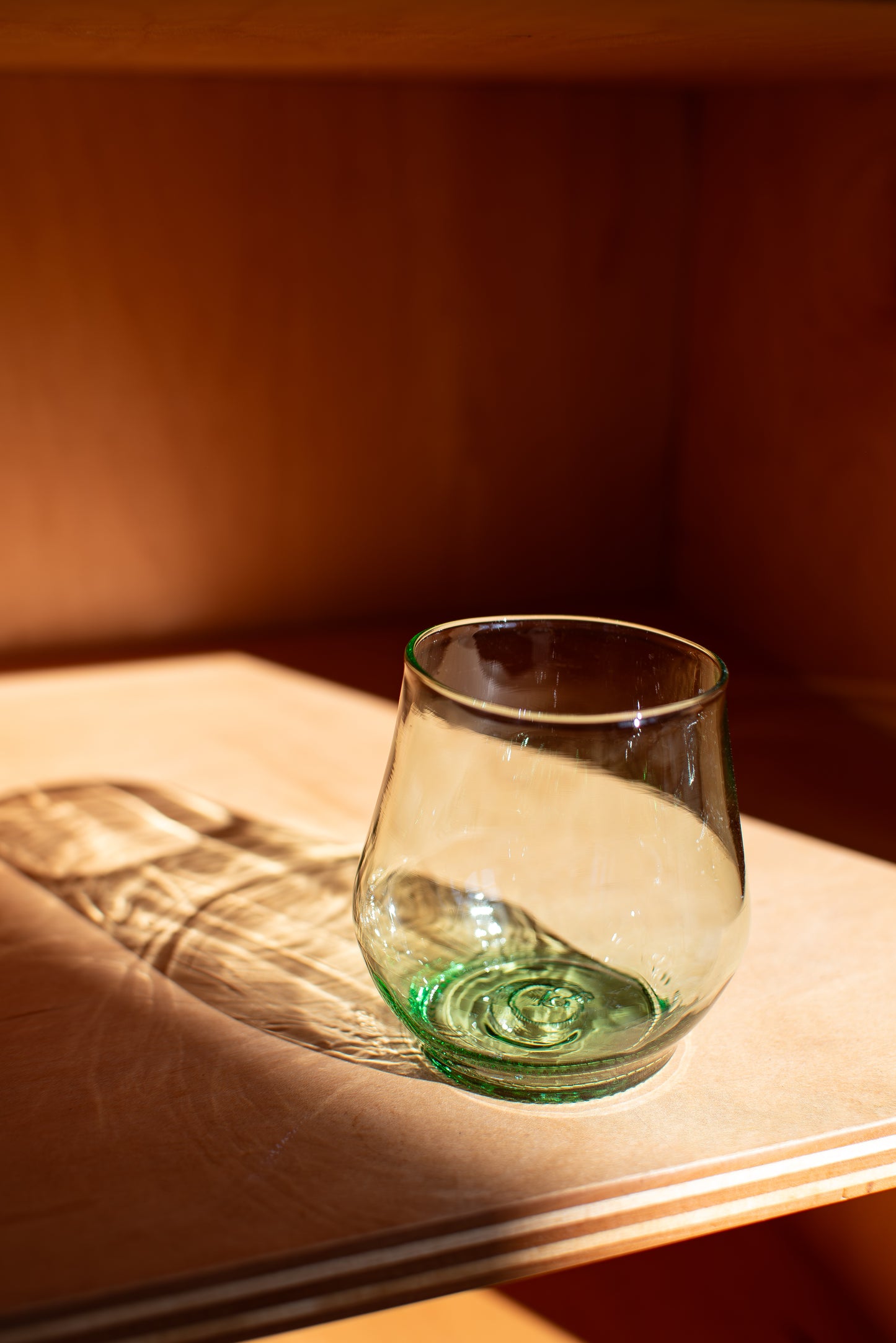 clear short glass with red background