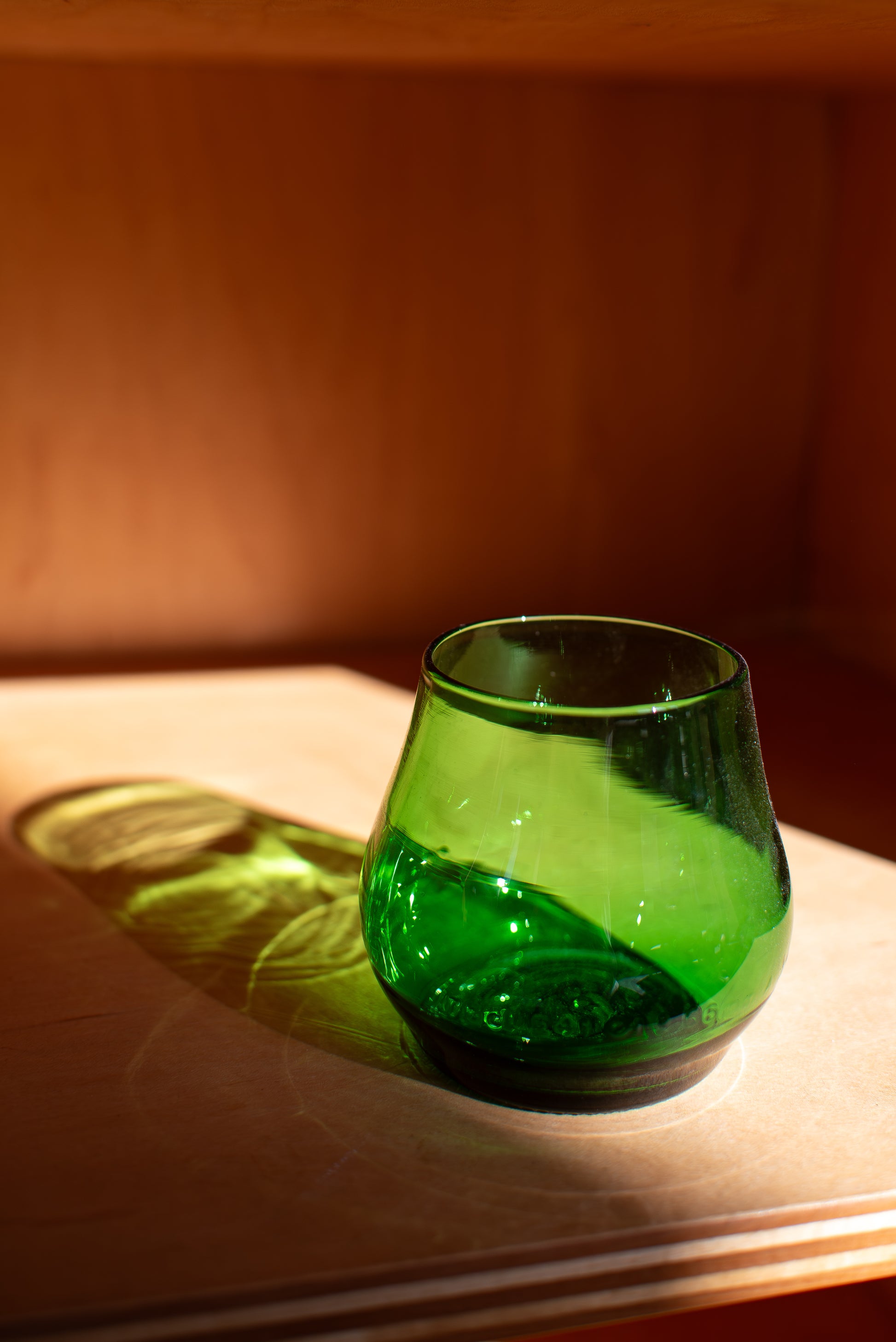 green short glass with red background