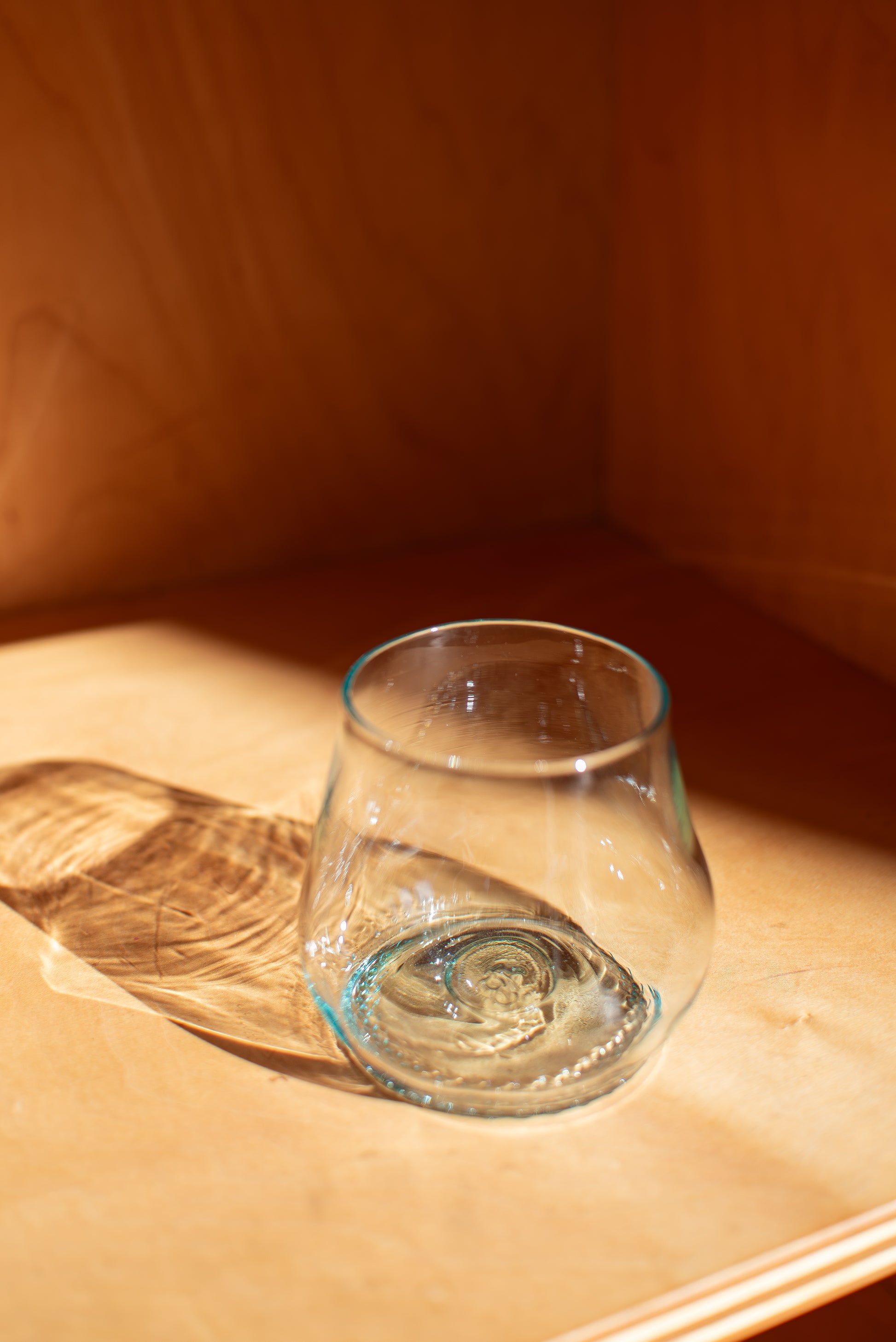 light blue short glass with red background