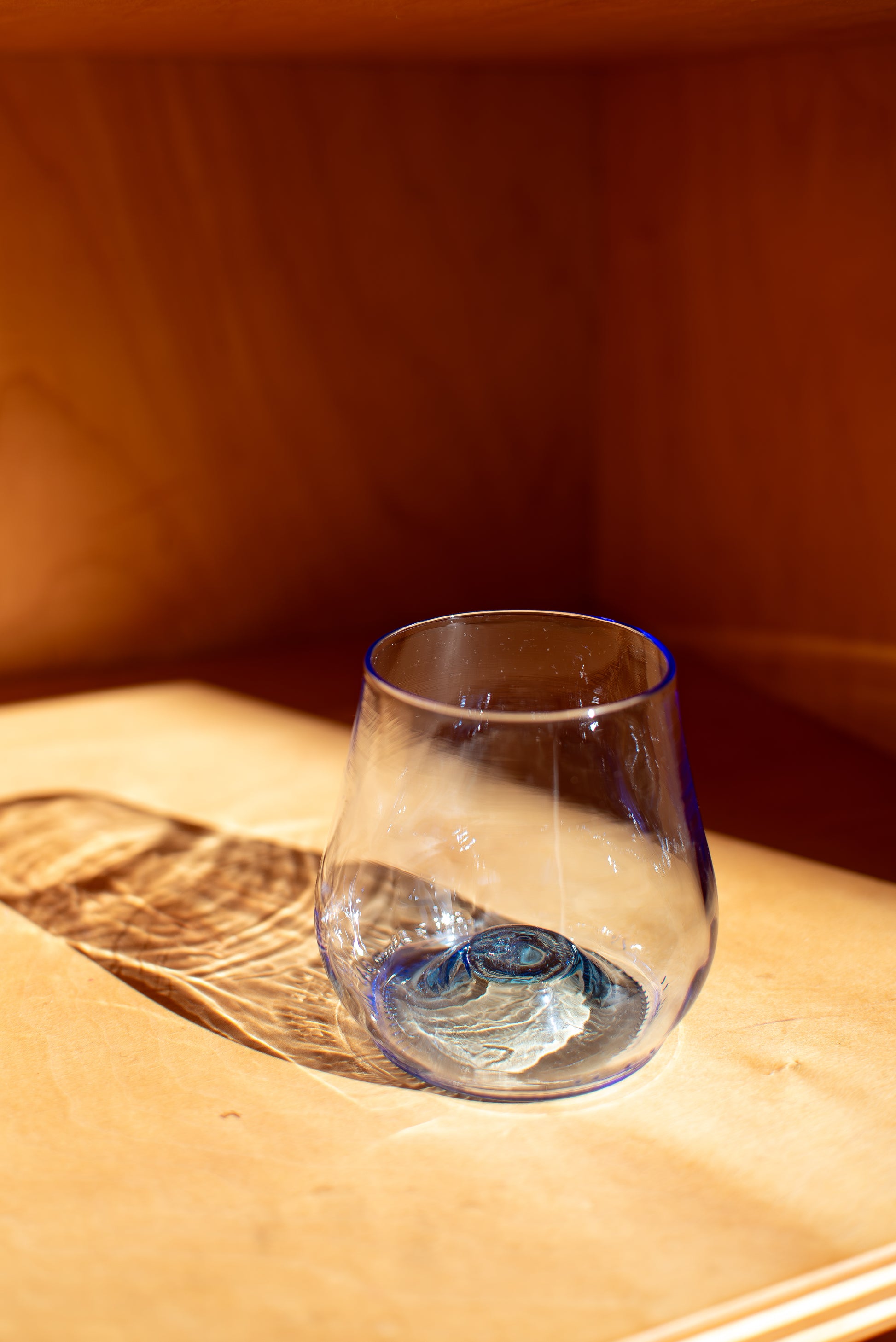 light blue short glass with red background