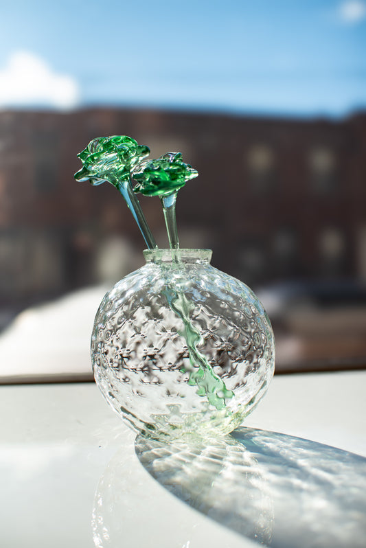 recycled bud base with glass flowers sitting on table