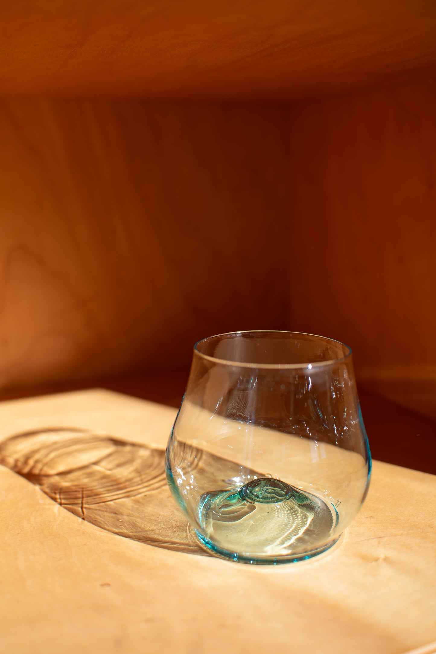 light blue short glass with red background