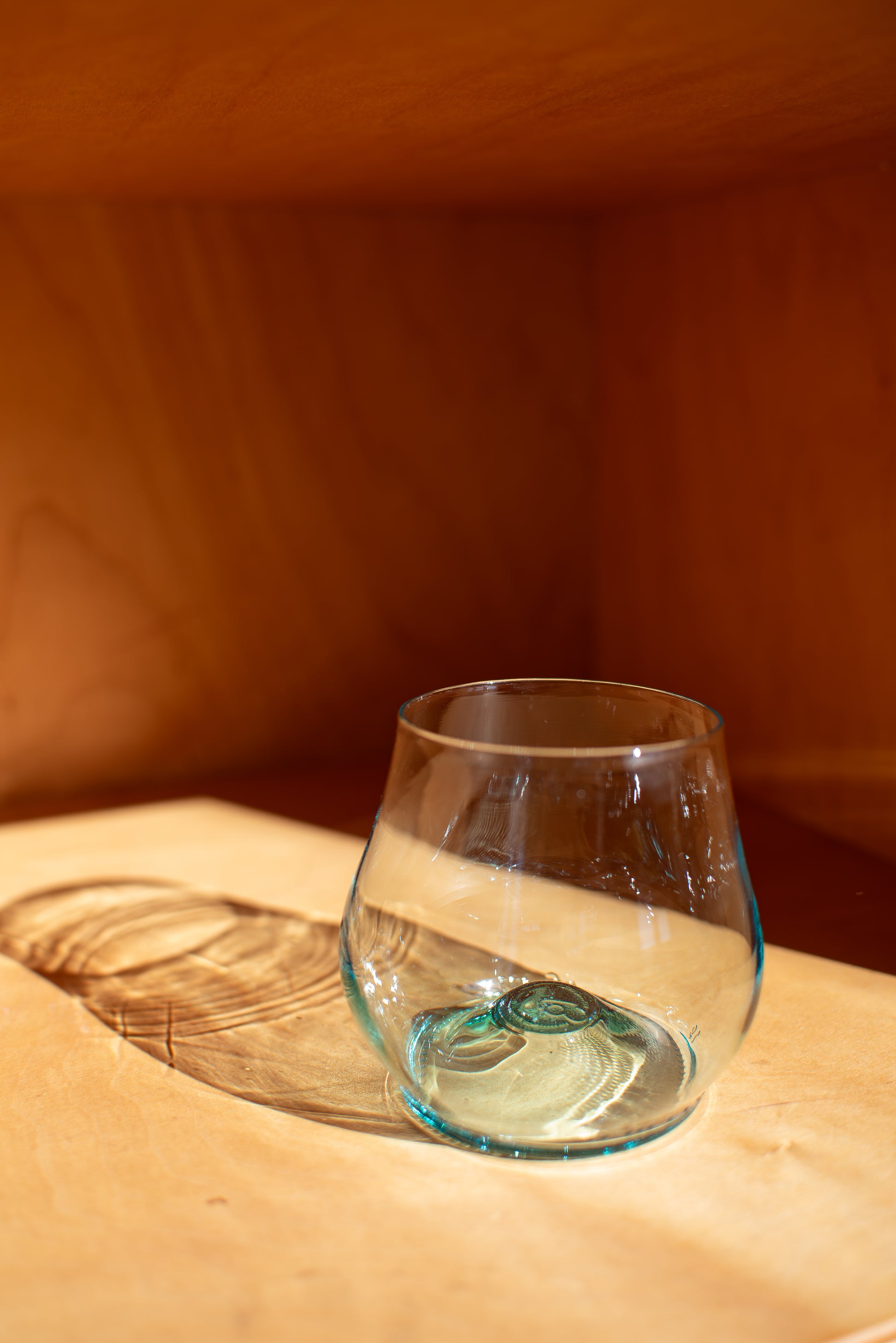 light blue short glass with red background