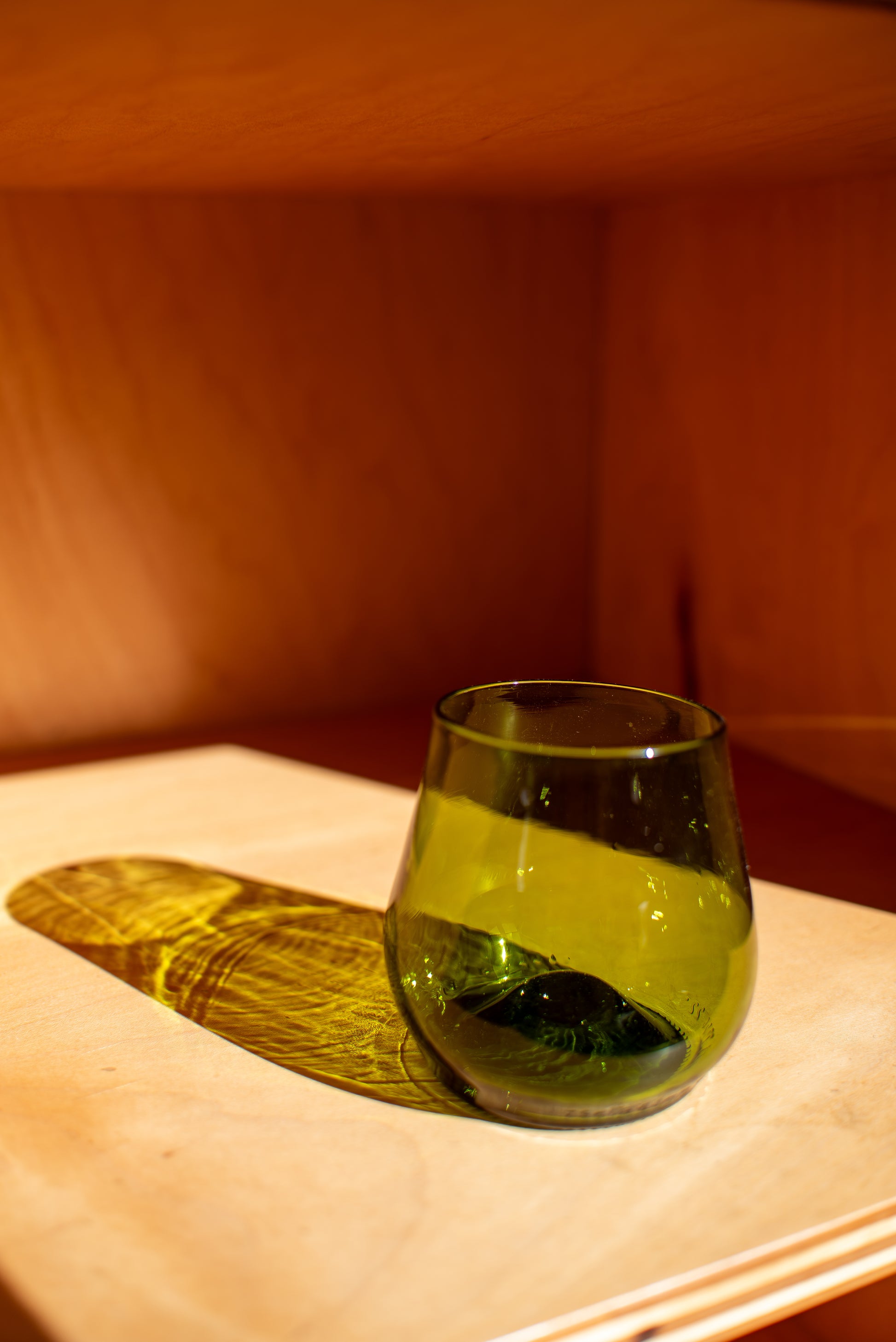 green short glass with red background