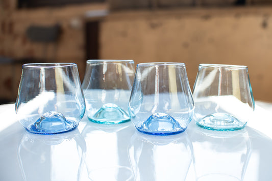 a set of short glass cups with light background and white table