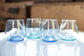 a set of short glass cups with light background and white table
