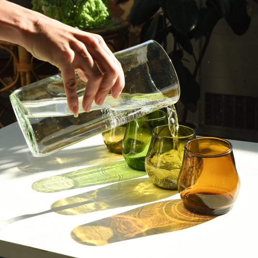 short glass cups, one being poured into