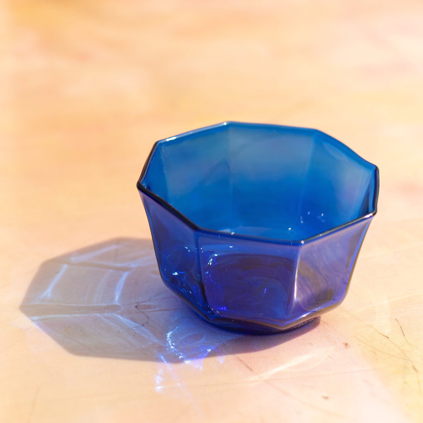 Blue geometric object on a wooden surface