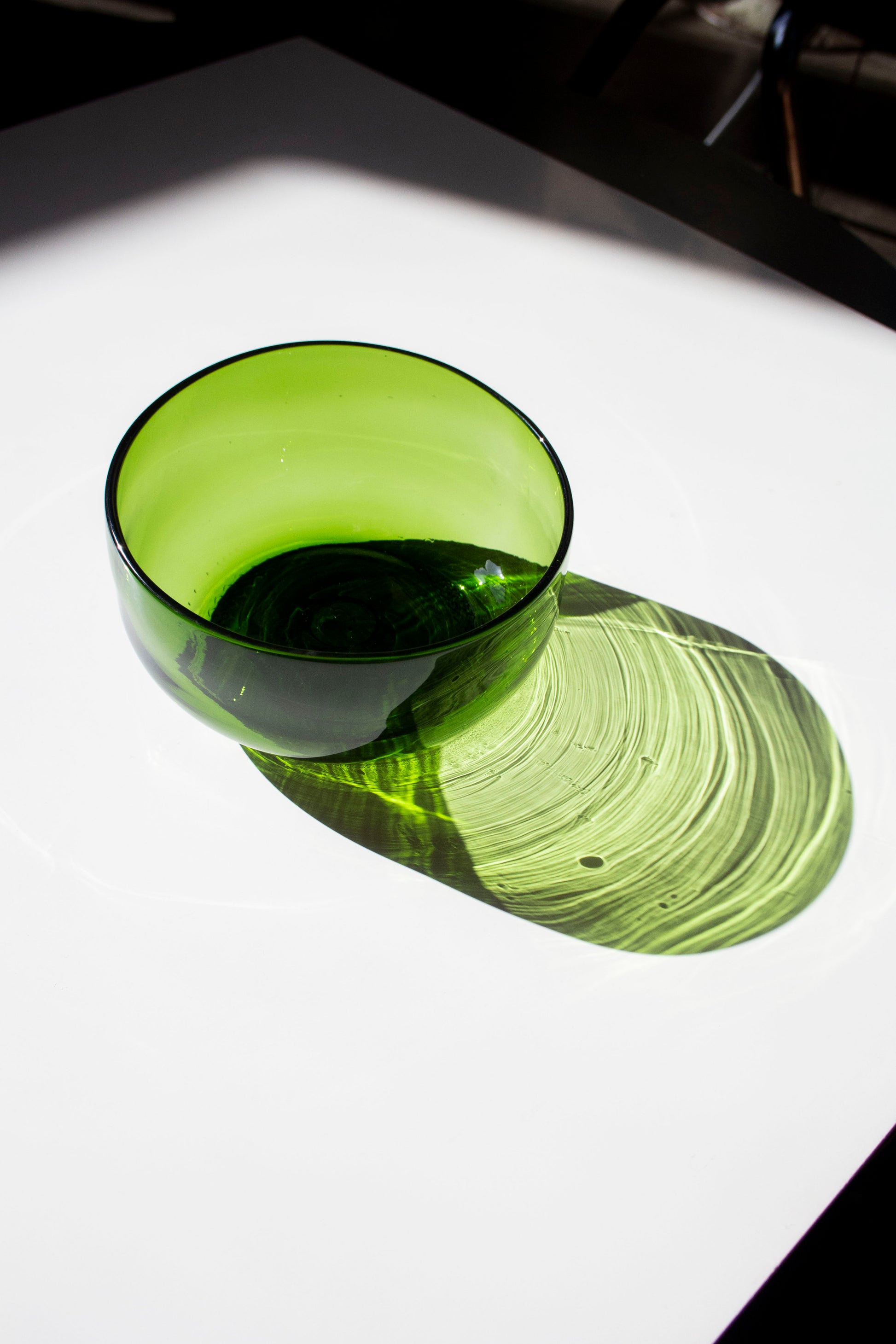 A small emerald serving bowl with a pretty shadow 