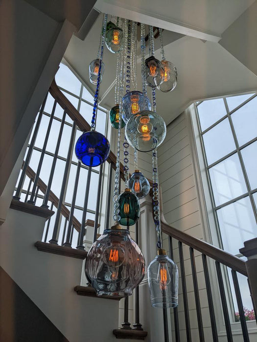 16 pendant chandelier with glass chain hanging in shore home staircase