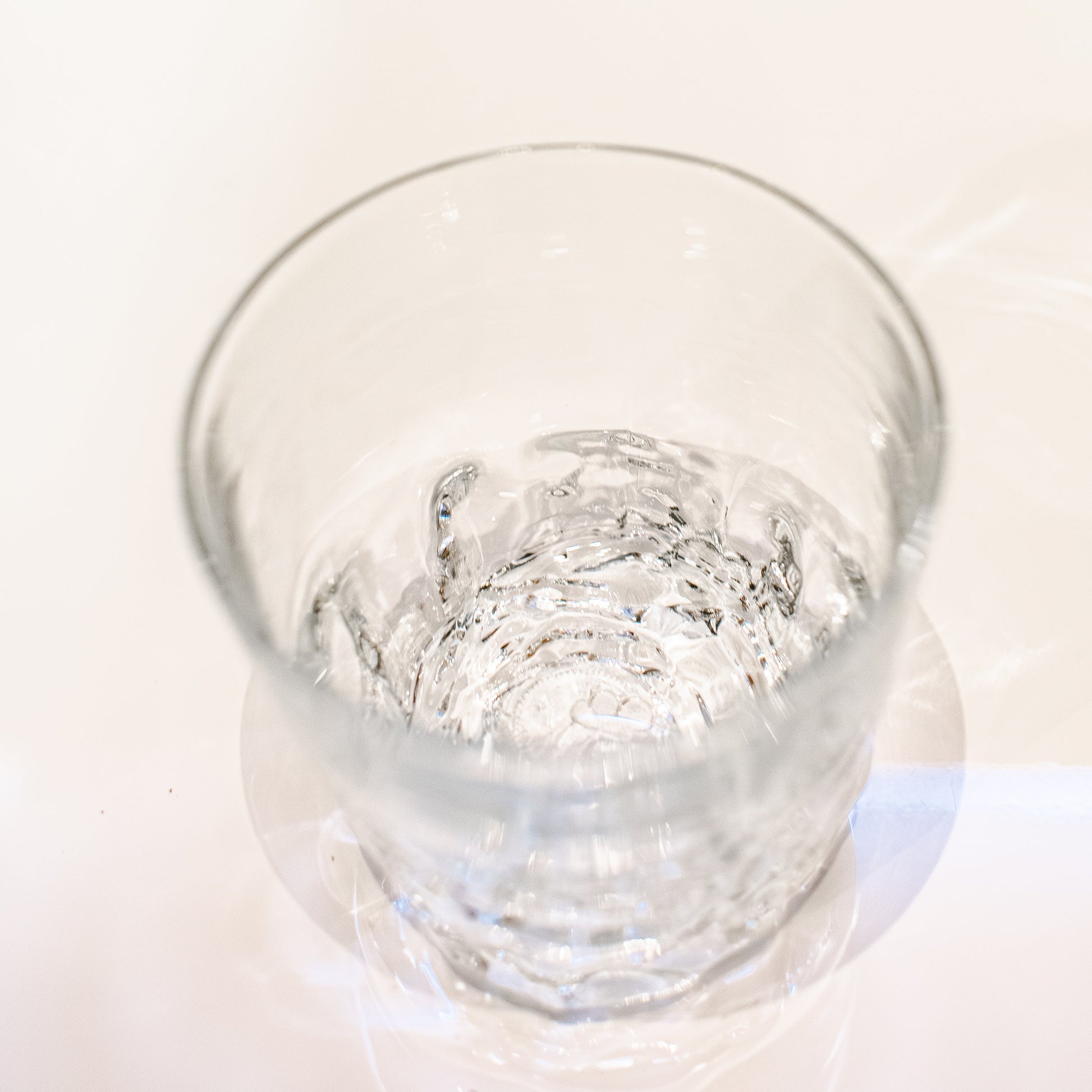 clear rocks glass with rose bottom