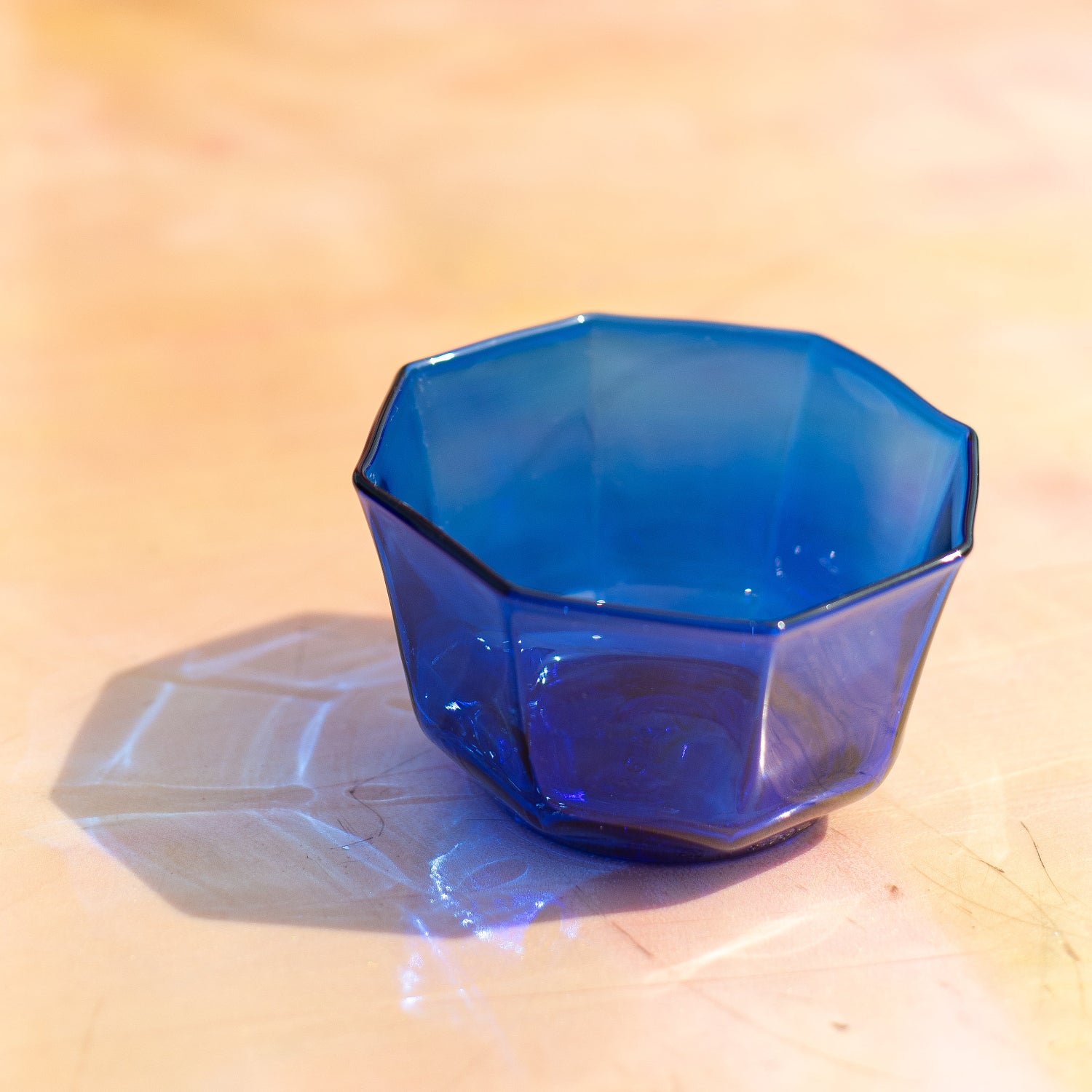 Blue geometric object on a wooden surface