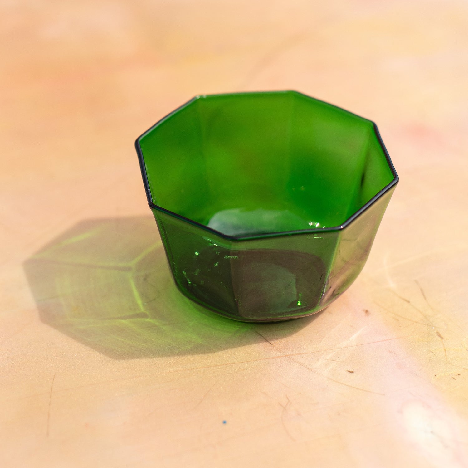 Green glass bowl on a wooden chair