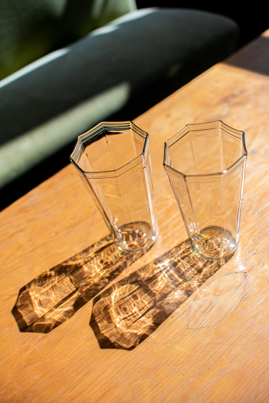 clear recycled glass water glasses with octagon top and reflection onto wood table