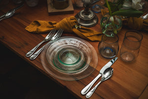 table setting with dinner plates made from recycled glass