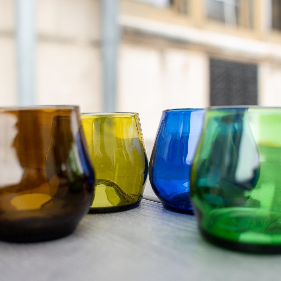 amber, gold, cobalt, and emerald wine glasses made from recycled glass
