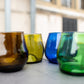 amber, gold, cobalt, and emerald wine glasses made from recycled glass