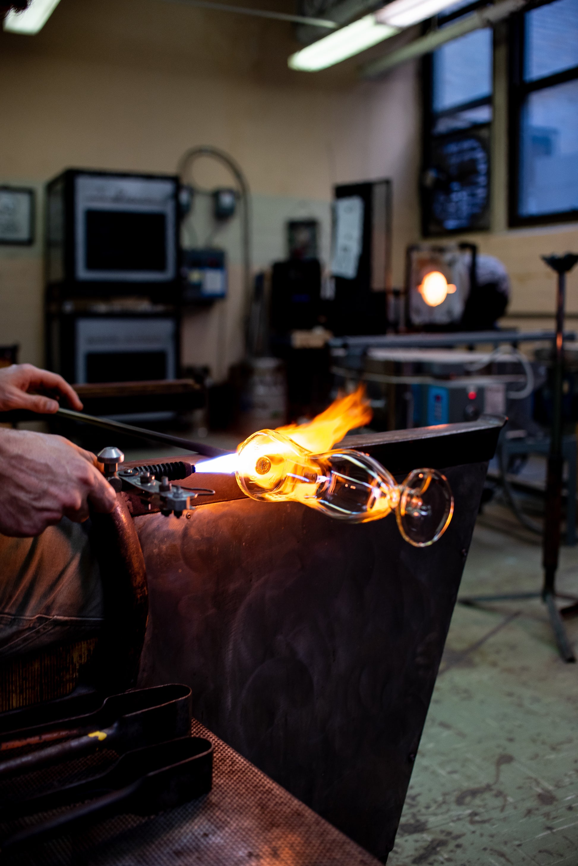 glassblower making upcycled tito's bloody mary glass