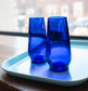 cobalt blue flutes made from recycled glass on light blue tray