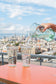 Recycled glass pitcher pouring sparkling water into two recycled water glasses with philadelphia skyline in the background